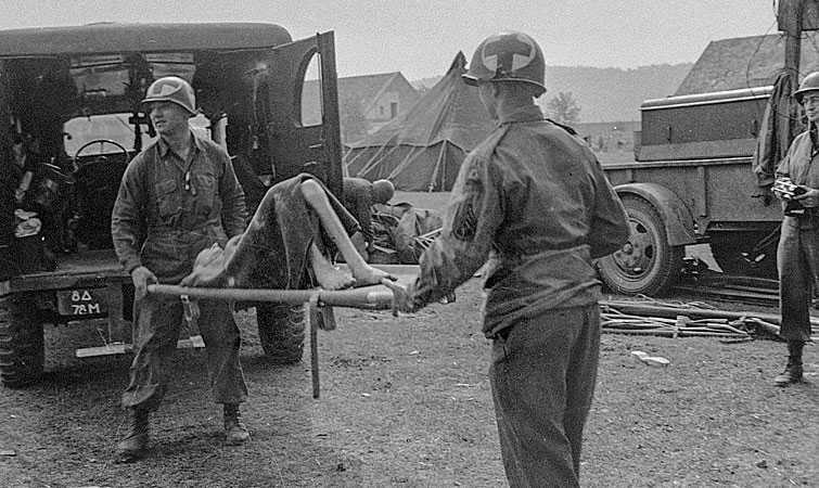 American medical personnel evacuate Langenstein survivors to a hospital.