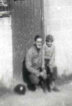 A picture from Felix's private collection, with an unknown GI and, as we believe, a local French boy on his knee in Cherbourg, France.