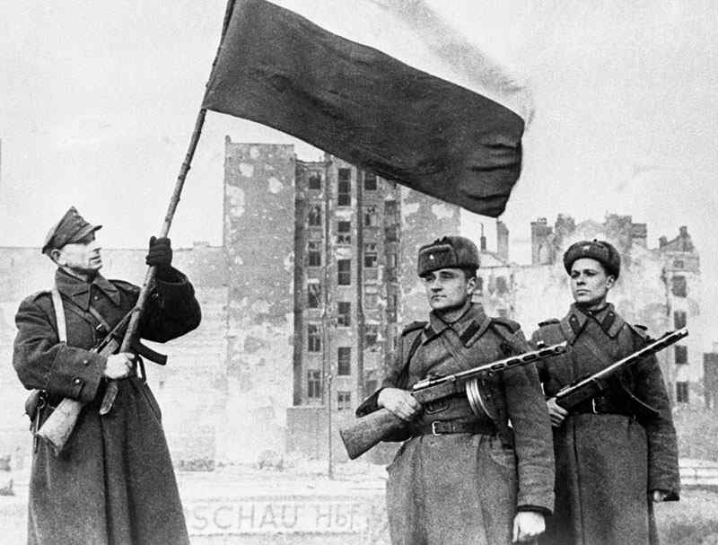 Soviet and Polish forces fly the national flag over Warsaw