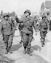 Three soldiers of the 506th leaving the area and going to the assigned meeting place.