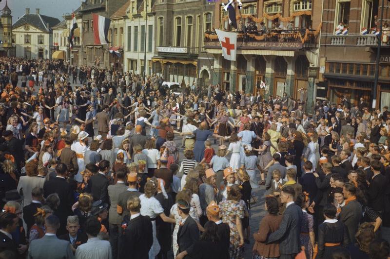 Civilians dancing in the square of Eindhoven, the first major town in Holland to be liberated. Eindhoven was later bombed by the German Air Force.