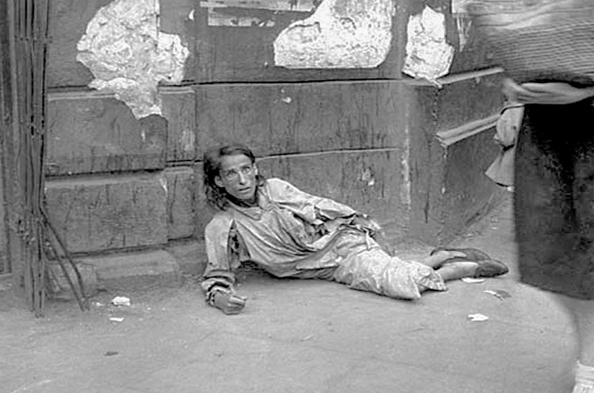 A starving woman lying on a ghetto street, Warsaw, Poland, September 19, 1941