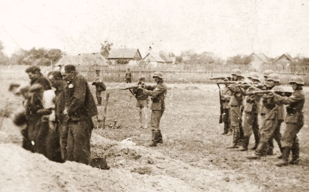 A group of civilians, likely Jews moments before execution.