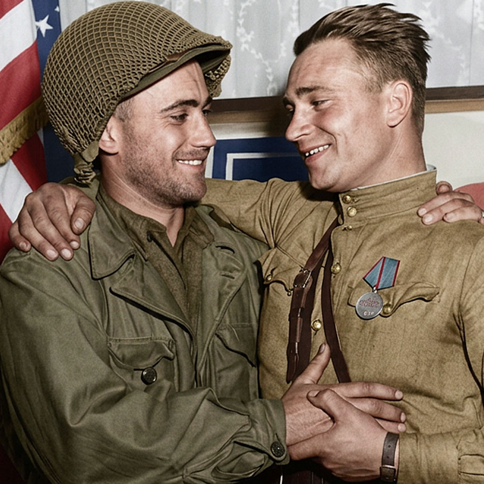 U.S. 2nd Lieutenant William Robertson and Lt. Alexander Sylvashko, Russian Army, in front of sign "East Meets West" symbolizing historic meeting of Russian and American Armies, near Torgau, Germany