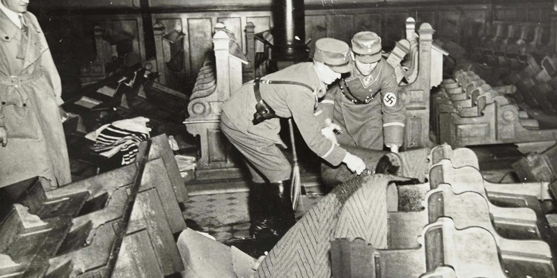Uniformed SA men ransack the interior of a synagogue during Kristallnacht.