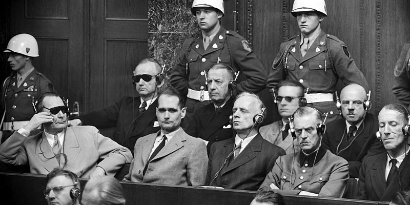 Nazi defendants, including Hermann Göring and Rudolf Hess, listen to translations in the prisoner's dock at the Nuremberg trials, circa 1945–1946.