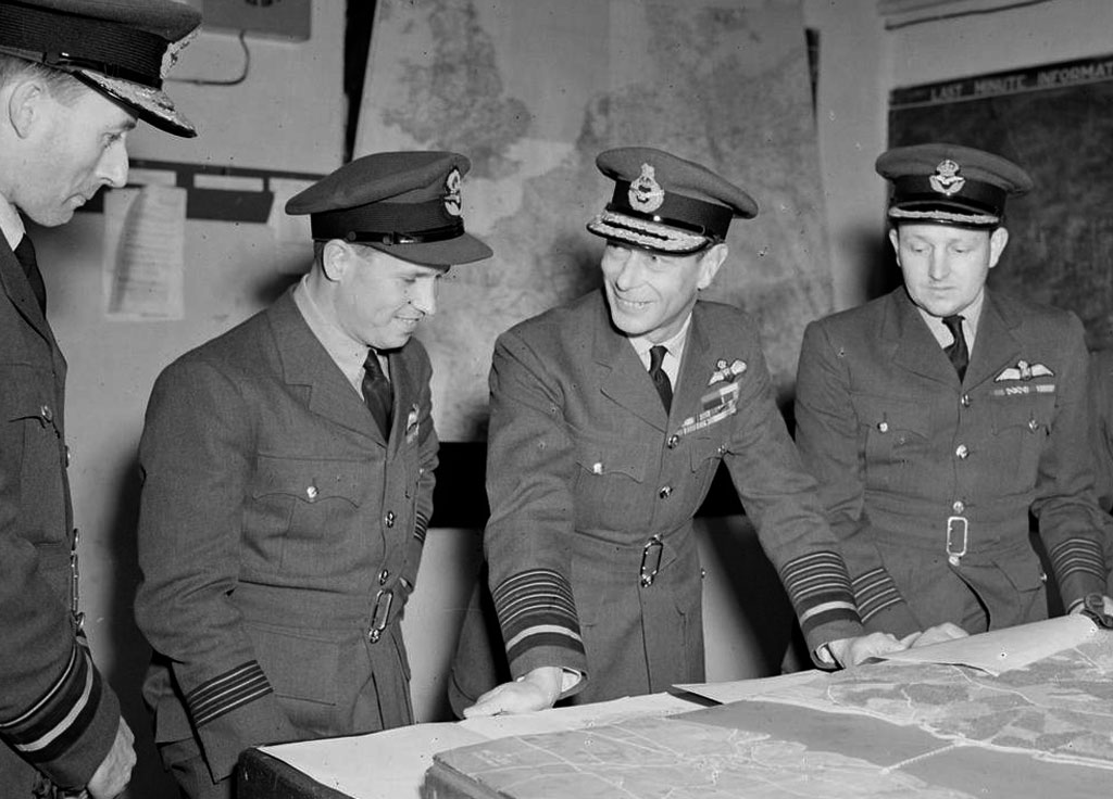Air Vice-Marshal Ralph Cochrane, Wing Commander Guy Gibson, King George VI and Group Captain John Whitworth discussing the Dambuster Raid in May 1943