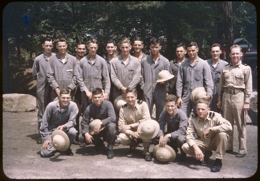 Trainee detachment in gray coveralls and pith helmets, Pine Camp