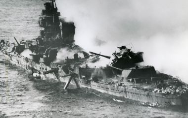 The heavy cruiser Mikuma burns after repeated attacks by American carrier aircraft on 6 June 1942. She became one of Japan's major naval losses following the Battle of Midway.
