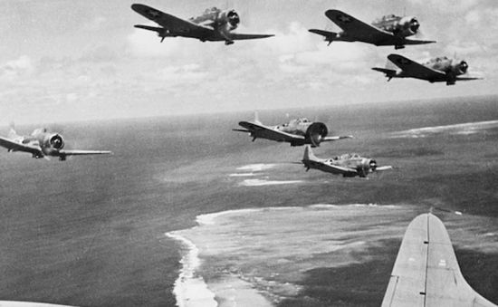Imperial Japanese Navy aircraft fly over Midway Atoll during the opening attacks on 4 June 1942, beginning one of the most decisive naval battles of the Second World War.