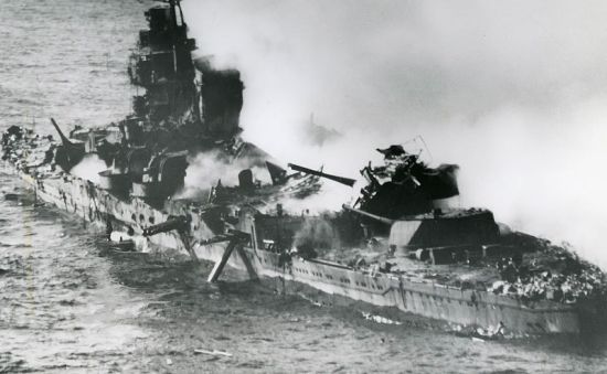 The heavy cruiser Mikuma burns after repeated attacks by American carrier aircraft on 6 June 1942. She became one of Japan's major naval losses following the Battle of Midway.