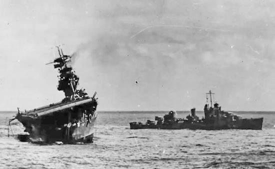 The abandoned USS Yorktown lists heavily after suffering bomb and torpedo damage during the Battle of Midway. She eventually sank on 7 June 1942.