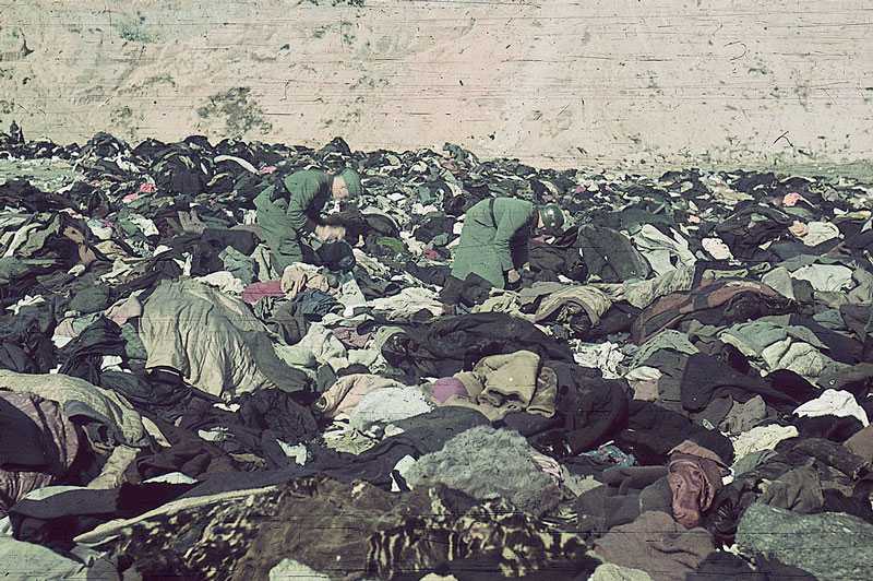 German soldiers looting the clothes left by the dead