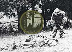86th Infantry medic approaches a wounded German soldier to see if he can help, riflemen in the background provide cover. This was near Rothenstein, Germany.