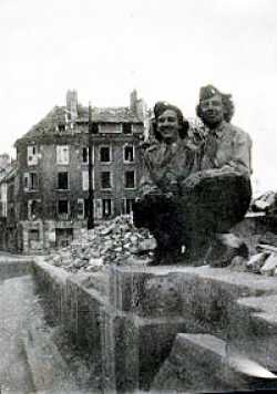 Elizabeth Hillmann with her friend Marian Agen, in St. Lo which was devastated by american bombs. Elizabeth went by train without food for several days because of fighting and arrived in Paris just after it was surrendered...