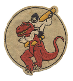This is a patch for the 327th Bombardment Squadron, 92nd Bomb Group.  The patch is worn on the left side of a flight jacket. The patch depicts a prehistoric cave man (Ollie OOP) ridding on a dinosaur (Denny) and charging into battle with a bomb in hand.