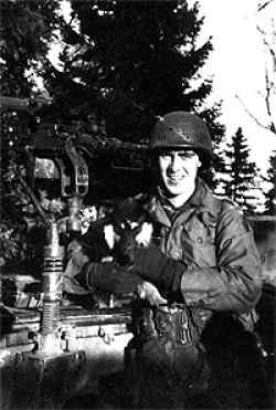 Dan in Belgium in December 1944 holding a dog.