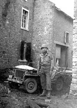 Glenn, standing in front of the jeep, waiting for General Rose.