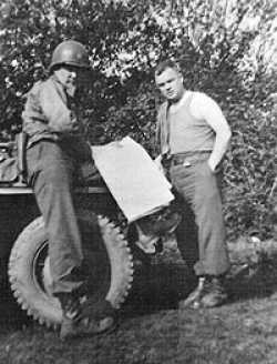 John Raaen on the left and Chaplain (Father) Joseph Lacy taken in Normandy shortly after the invasion.