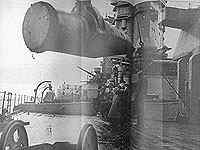 One of the 16 inch shells being hoisted aboard H.M.S. Rodney.