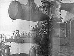 One of the 16 inch shells being hoisted aboard H.M.S. Rodney.