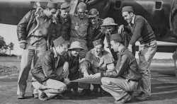 Members of the 100th Bomb Group  at RAF Thorpe Abbotts on August 17, 1943. Frank D. Murphy, is kneeling on the left with a dagger in his pocket.