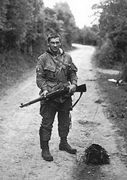 Pfc. Forrest L. Guth on the road to Carentan, Normandy, France