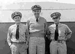 The officers of the USLCGL 687: (Left) Ensign D. A. Glover (Right) Ensign E. B. Murray (Center) Lieutenant Bob Coop