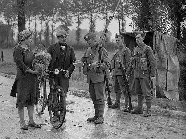 Men of the 1st Battalion, Royal Berkshire Regiment checking the papers of civilians at Becun