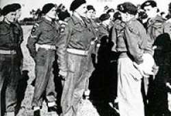Arthur standing in the back while Montgomery inspects the troops.