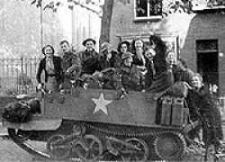 This is marked "With the first troops to liberate Tilburg Holland, October 44" Bill Charles (driver) bareheaded in front of carrier.After several attempts, cannot identify which part of Tilburg this is, if anyone recognises the area, or the family in the picture, please contact me.