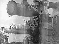 One of the 16 inch shells being hoisted aboard H.M.S. Rodney.