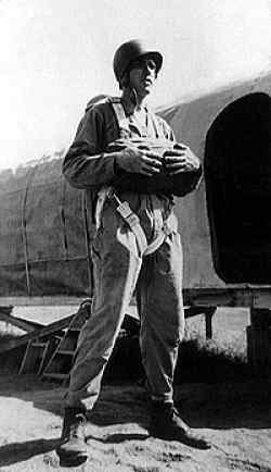 During basic parachute infantry training at Camp Toccoa, Georgia, fall of 1942. Mock-up plane for practice jumps in the background.