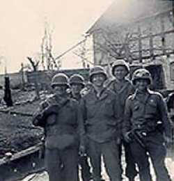 From left to right, S/Sgt. Al Holland, supply sergeant; Pfc. Talley F. Kelley, machinegun platoon; Cpl. Mitchell Kaidy, assistant company clerk/mail clerk; Pfc. Howard Hager, jeep driver; Pfc. Joseph DeMasi, machinegunner.