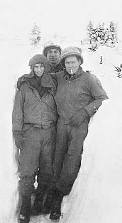 Earl in the snow near the Elsenborn Ridge. Earl is on the left , Sgt.Harold Combes next to him, Richard Tanner in the back. I have lost touch of Sgt. Combes but see and talk to Tanner often.