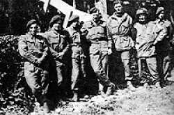 Denis Edwards at the Chateau St Côme in late July, with Major John Howard and "D" Company's snipers. Left to right: "Wackers" Waite, "Pete" Musty, "Nobby" Clarke, John Howard, "Rocky" Bright, "Paddy" O'Donnell, and Denis Edwards. Corporal Wally Parr is not amongst the group, having been wounded earlier in the fighting.