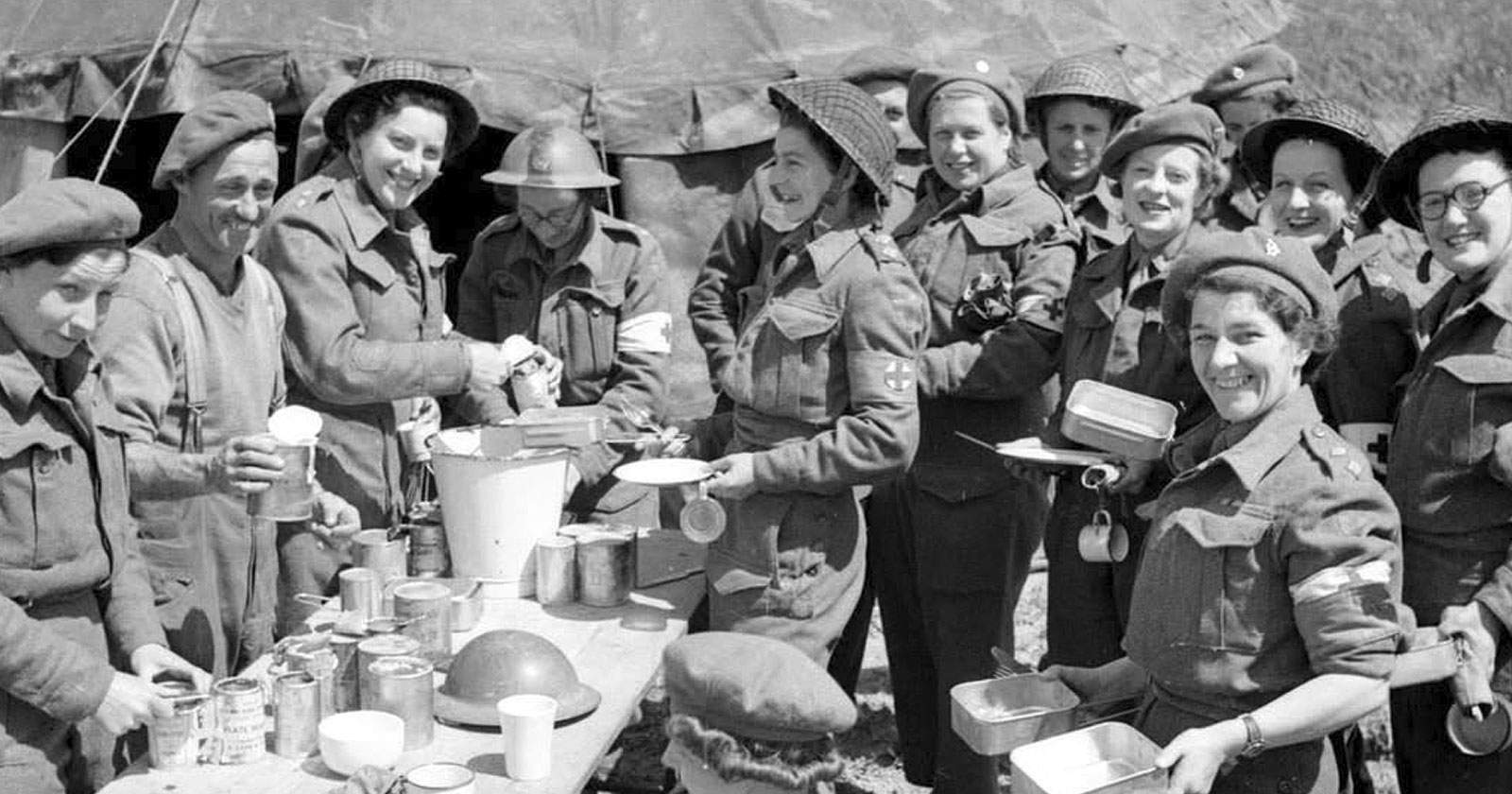 Nurses of the Queen Alexandra’s Imperial Military Nursing Service (QAIMNS) pause for lunch at No. 88 Field Hospital near Douvres-la-Délivrande, Normandy, June 22, 1944.